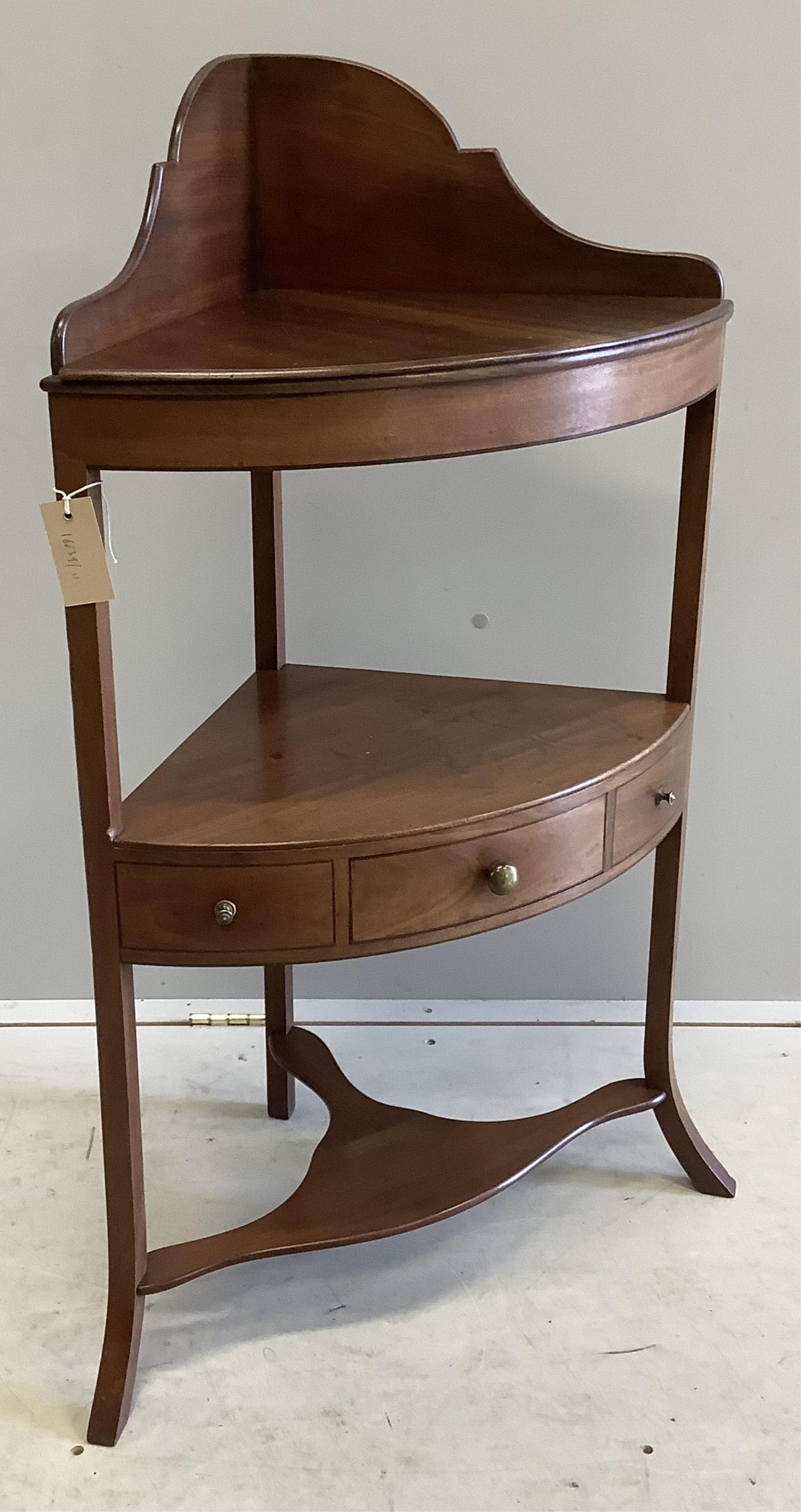 A George III mahogany two tier bow front corner washstand, width 57cm, depth 37cm, height 99cm. Condition - fair